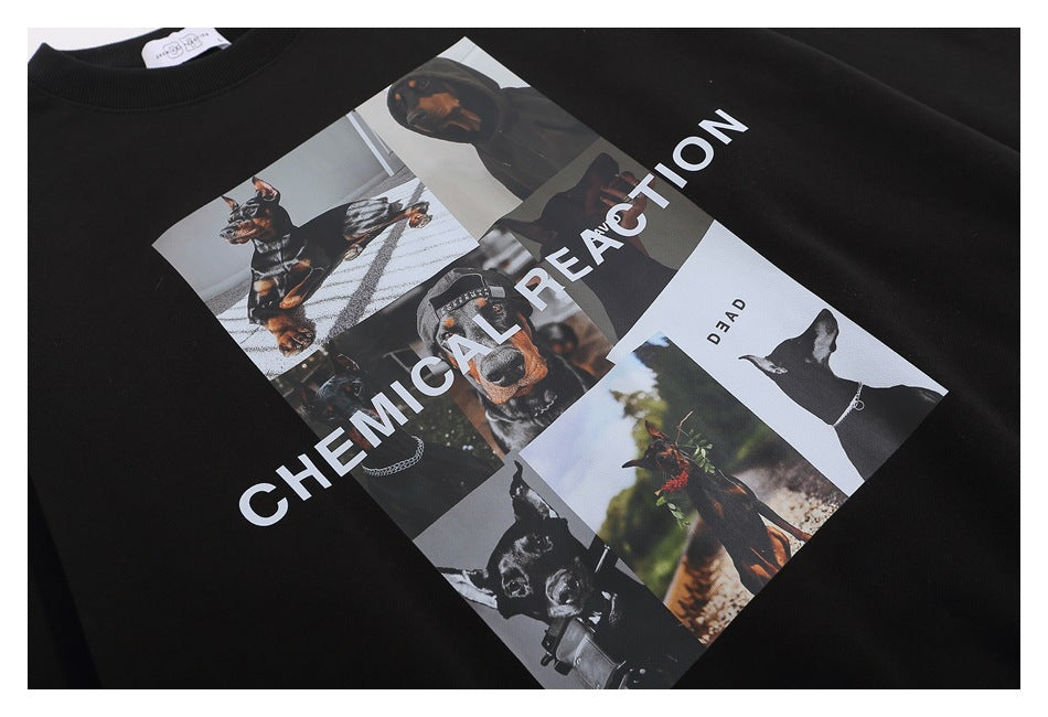 Flat lay of a black crewneck sweatshirt with a large collage of dogs and people and white “CHEMICAL REACTION” lettering.