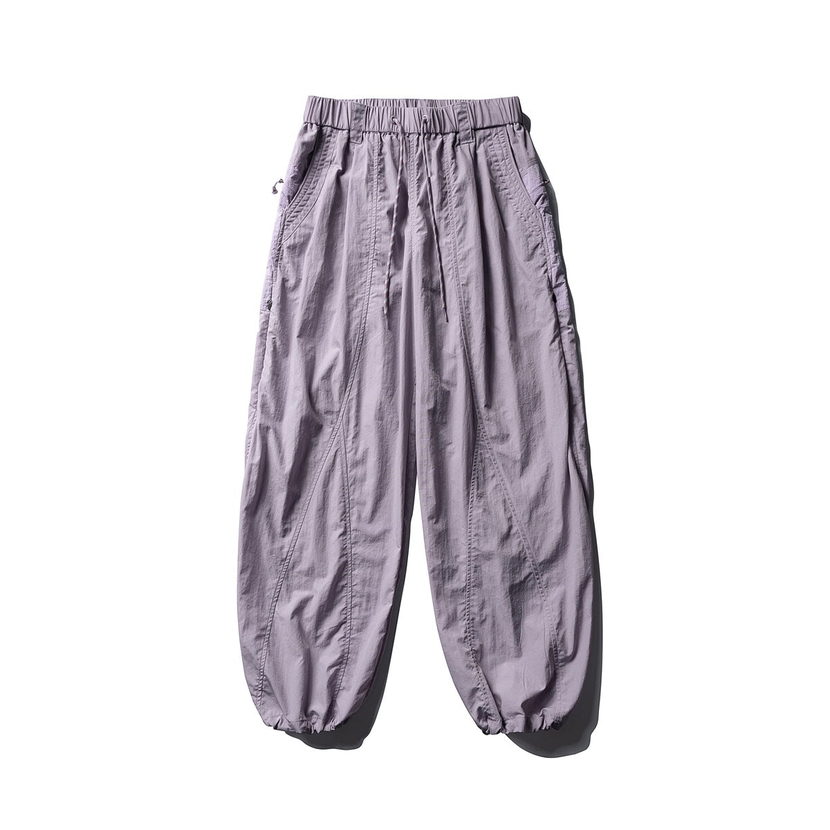 Front view of pale lavender, loose-fit pants with a drawstring elastic waist, slanted pockets, and gathered cuffs.