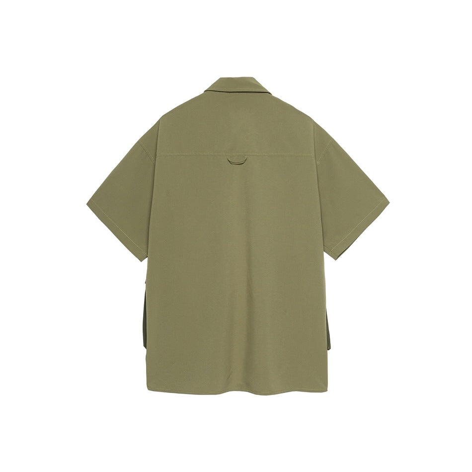 Back view of khaki green short-sleeve shirt with yoke seam, small loop tab and side vents
