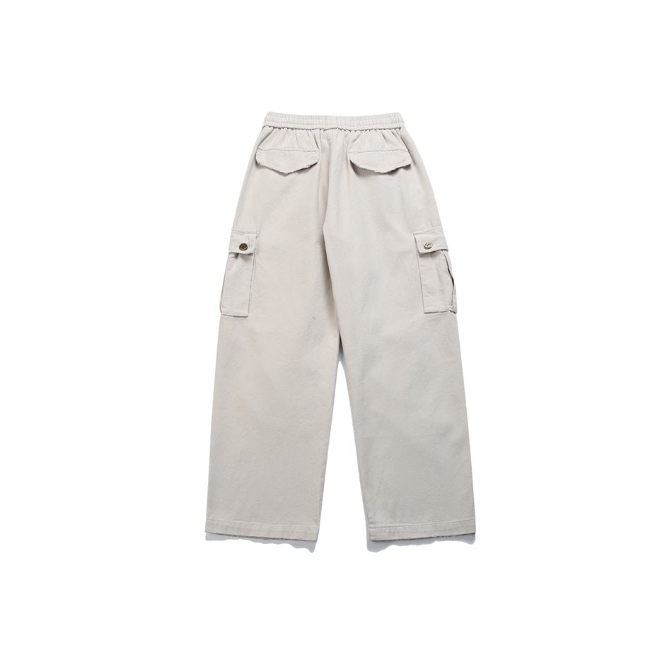 Back view of light beige wide-leg cargo pants with an elastic waist, two rear flap pockets and buttoned side cargo pockets.