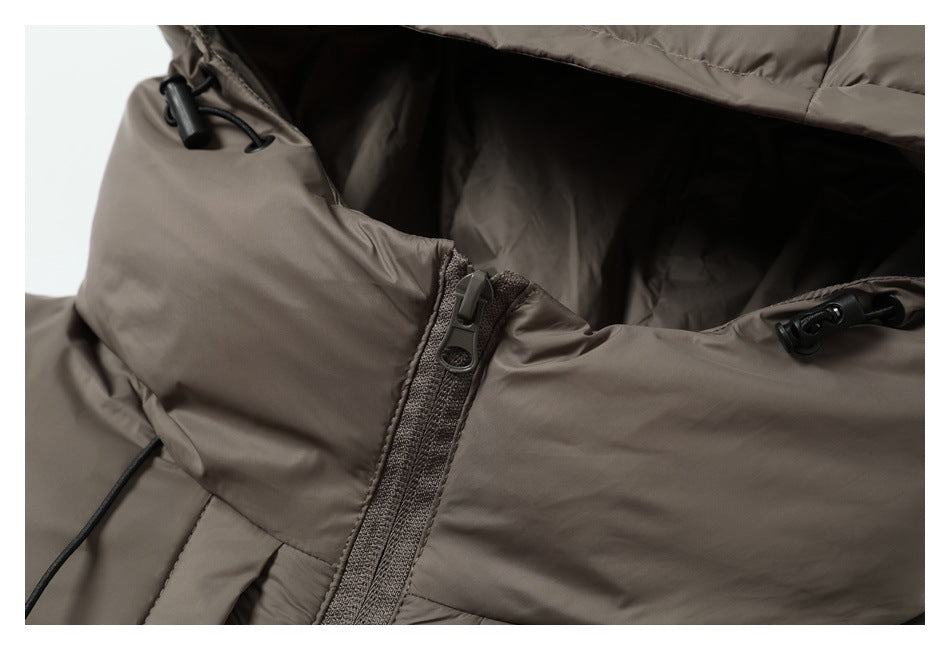 Close-up of a taupe padded jacket showing the zipper, hood opening, and black drawcord toggles.