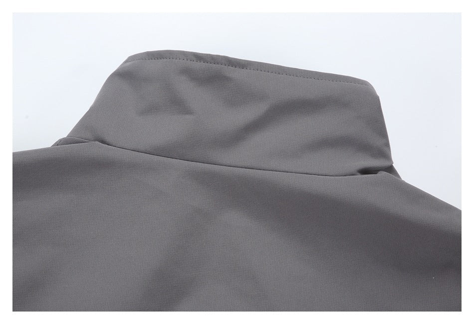 Close-up of the raised collar and upper back of a dark gray garment.
