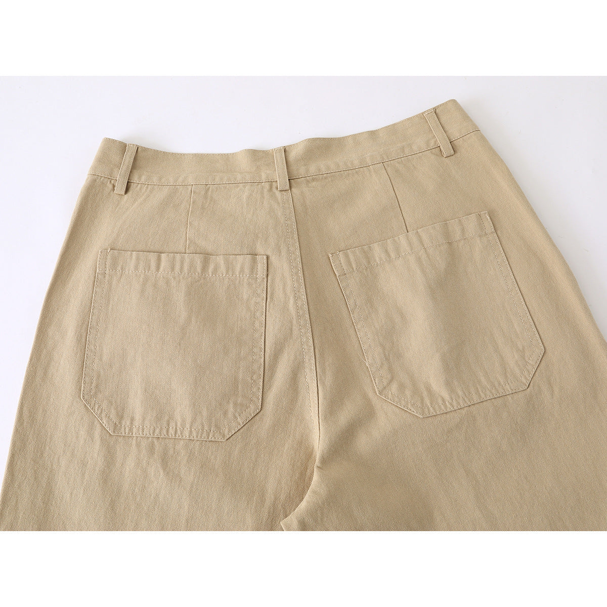 Close-up of the back of tan trousers, showing the waistband, belt loops and two patch pockets.