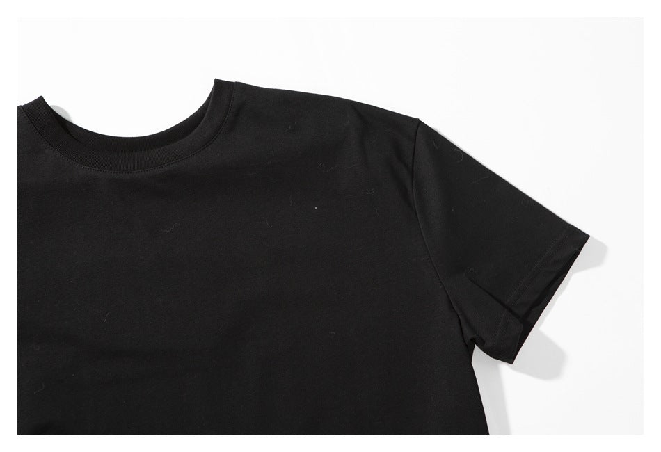 Close-up of the right shoulder and short sleeve of a plain black T-shirt.