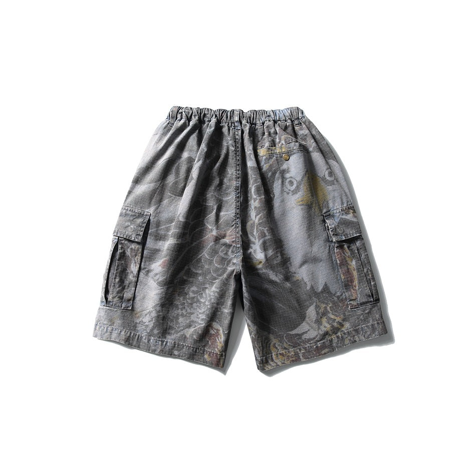 Back view of gray cargo shorts with faded graphic-patterned fabric, an elastic waist, buttoned rear pocket, and side cargo