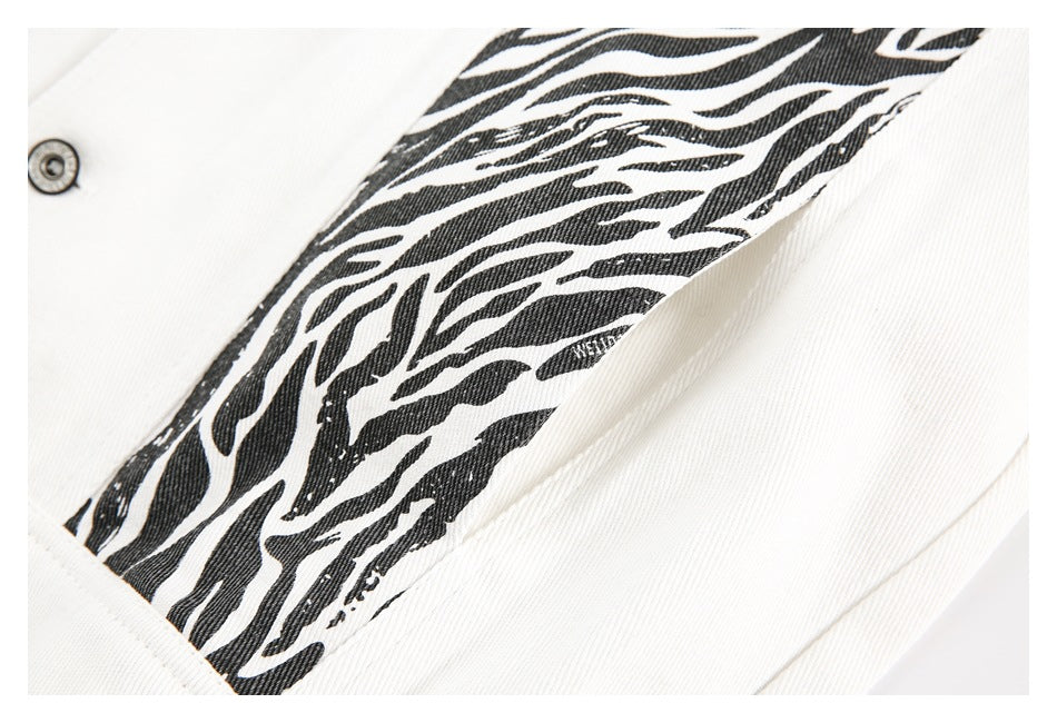 Close-up of a bold black zebra-pattern strip between panels of white denim.