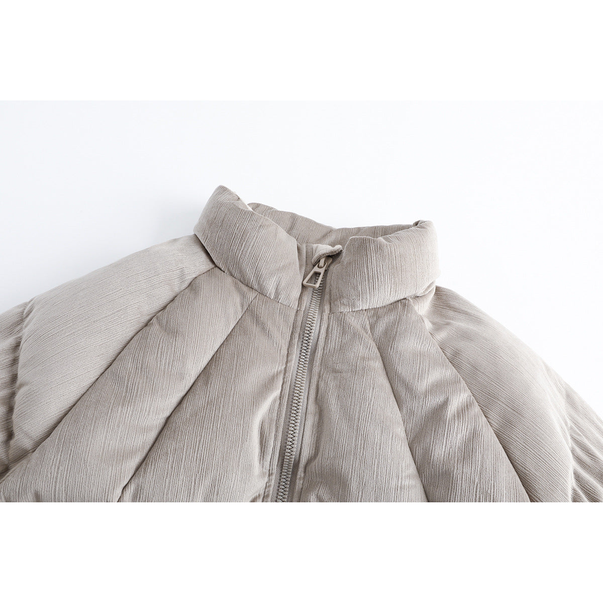 Close-up of a light taupe padded jacket's high collar, textured fabric, and front zipper.