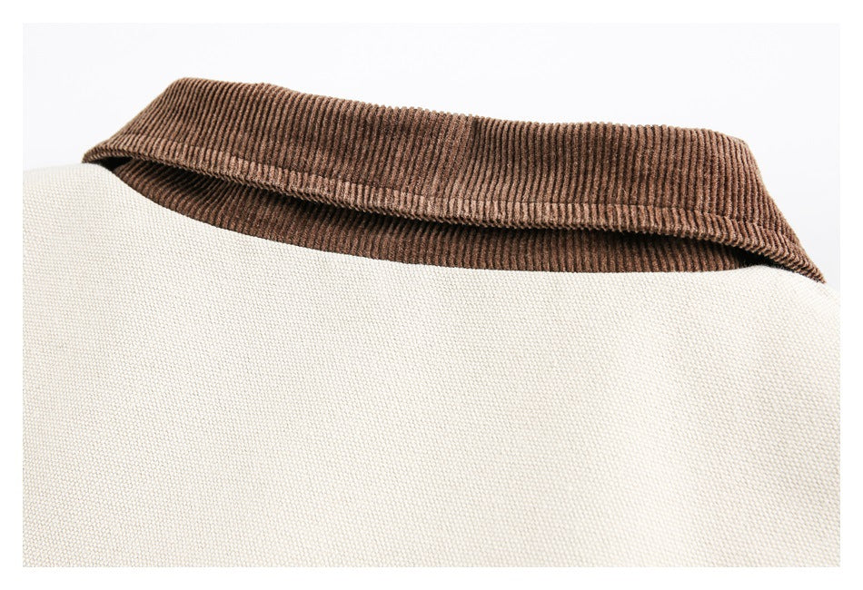 Close-up of a brown ribbed collar on a cream garment.