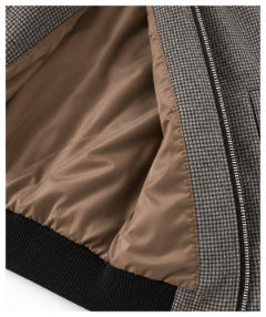 Close-up of the jacket opened to show its smooth brown lining and black ribbed hem.