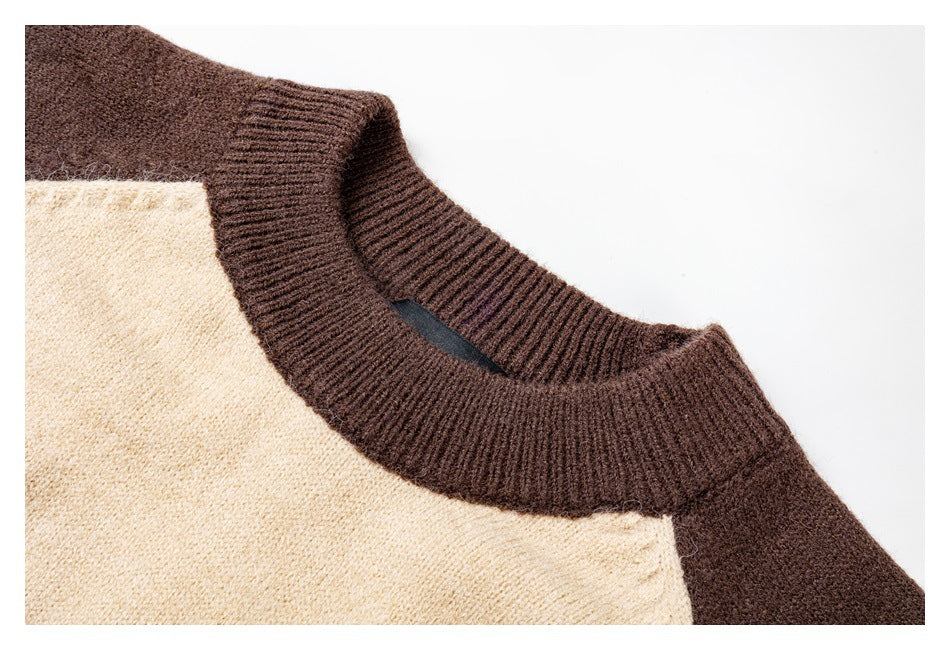 Close-up of the sweater’s ribbed dark brown crew neckline and cream knit body.