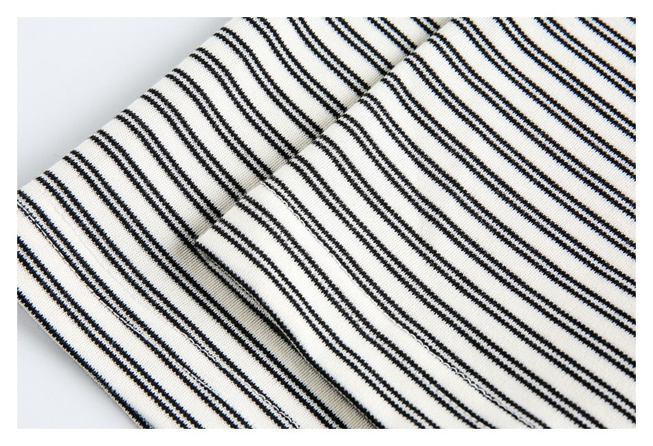 Close-up of black-and-off-white striped garment fabric with a visible seam.
