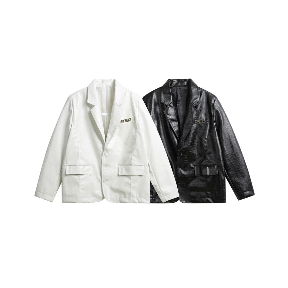 White and black crocodile-embossed blazers displayed side by side, both with notched lapels and flap pockets.