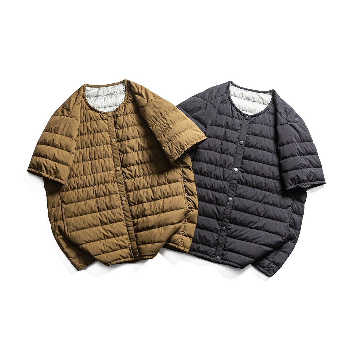 Two short-sleeve quilted jackets laid flat, shown from the front in brown and charcoal gray.