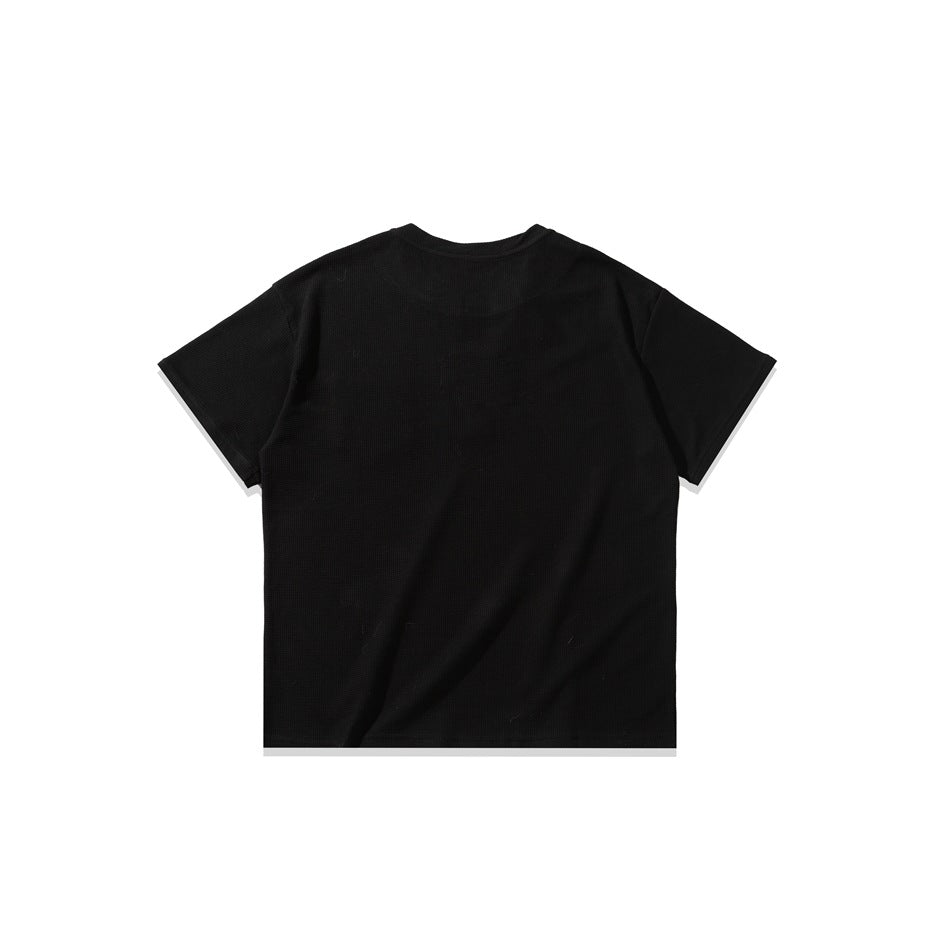 Back view of a plain black short-sleeve shirt laid flat against a white background.