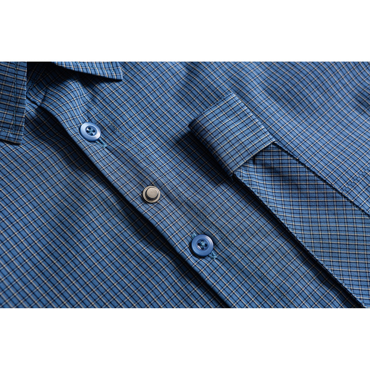Close-up of a blue plaid shirt showing its buttons, placket, and cuff.