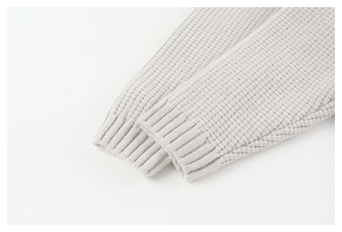 Close-up of the light gray cardigan's long sleeve and ribbed cuff.