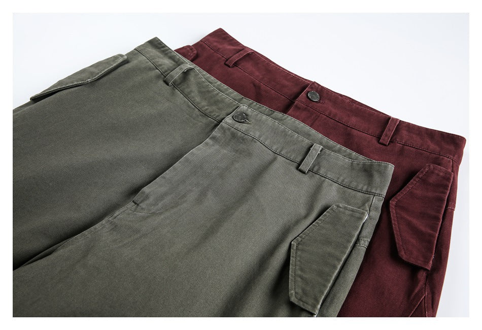 Overlapping olive and burgundy cargo pants, showing the waistbands, front closures, and side pockets.