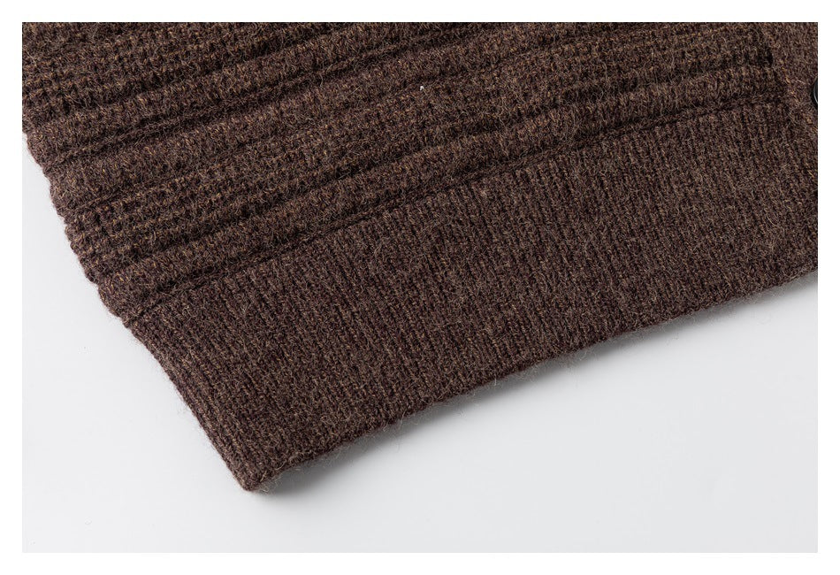 Close-up of a ribbed hem on a dark brown textured knit garment.