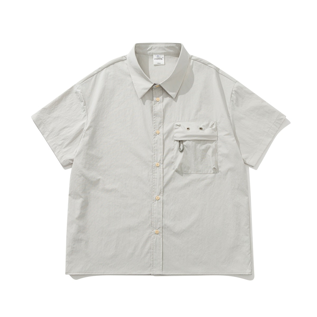 Light gray short-sleeve button-up shirt with chest pocket with eyelets, flat lay front view