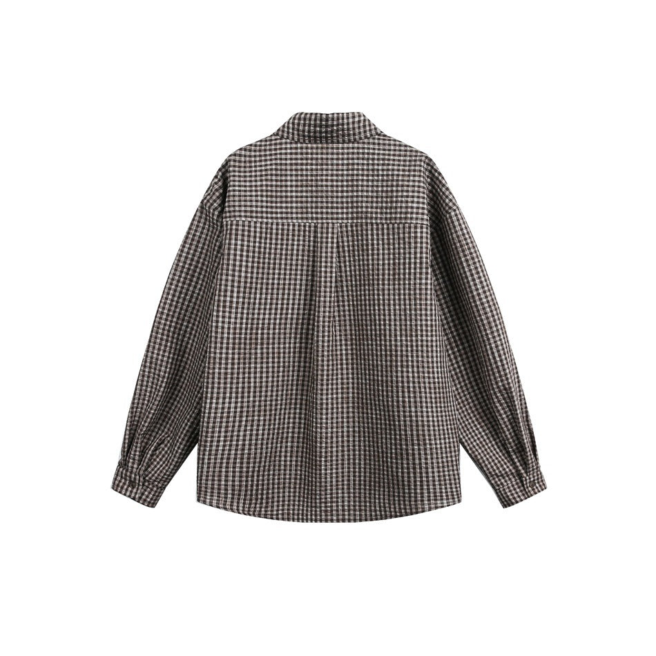 Back view of a long-sleeved brown and black gingham shirt with a stand collar and center pleat.