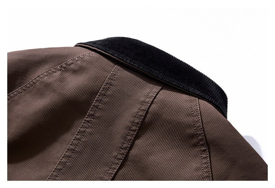 Close-up of the brown jacket's black ribbed collar and shoulder stitching.