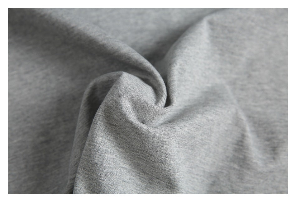 Close-up of the heather gray shirt fabric gathered into soft folds.