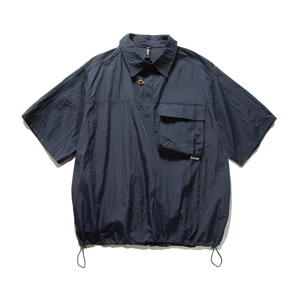 Navy short-sleeve collared pullover shirt with a flap chest pocket and drawstring hem, flat view
