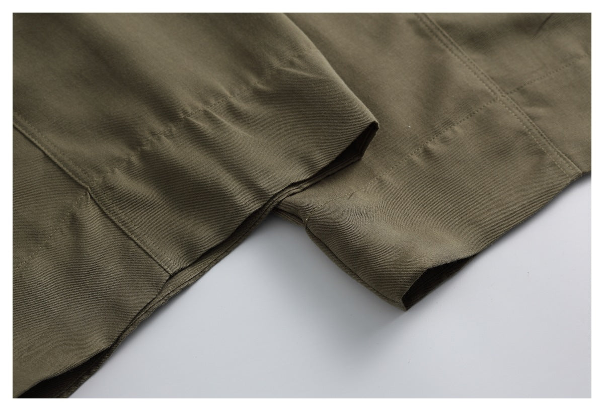 Close-up of olive-brown trouser legs showing the stitched hems and seams.