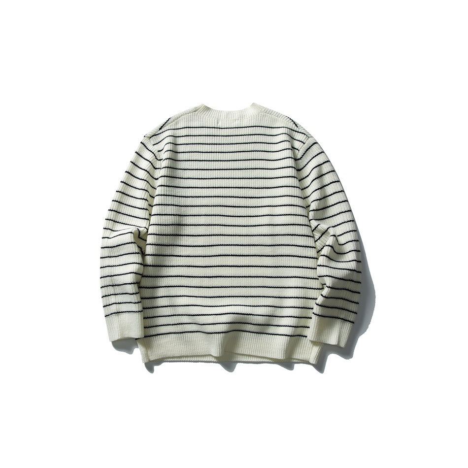 Ivory rib-knit crewneck sweater with thin black horizontal stripes, shown flat against a white background.