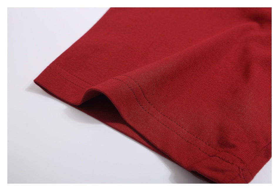 Close-up of the dark red T-shirt sleeve hem and double-row stitching.