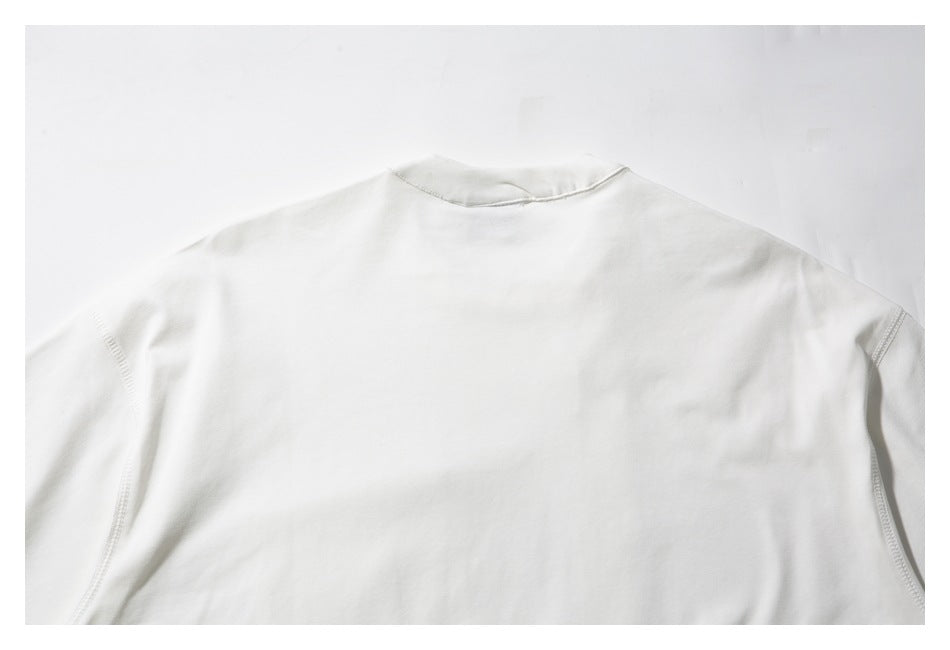 Back view of a plain white shirt laid flat, showing the collar and shoulder seams.