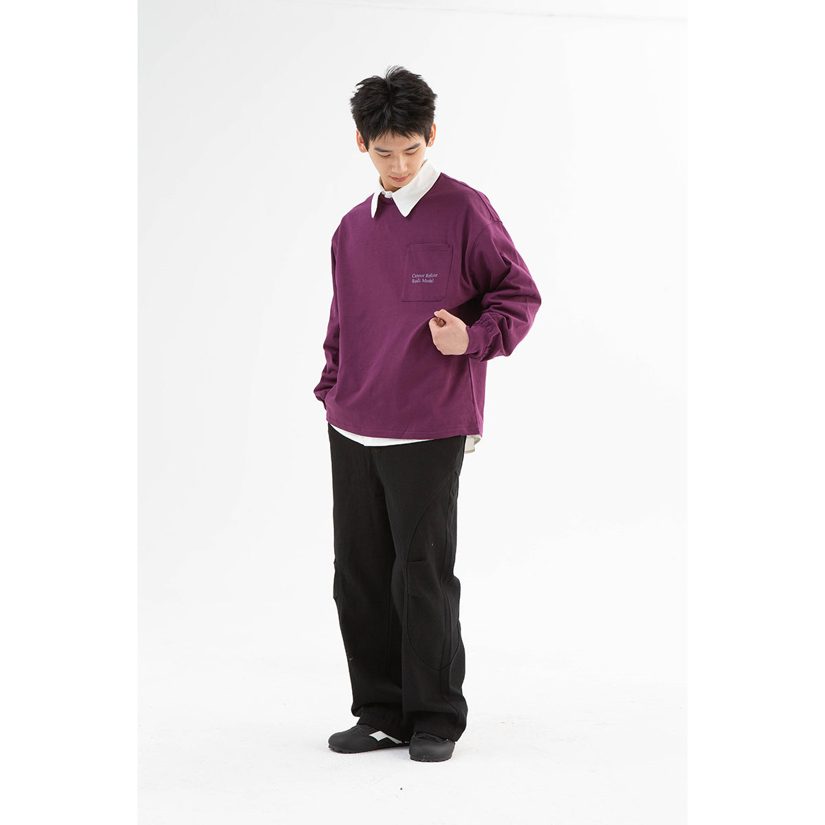 Model wearing a plum long-sleeve shirt with a white collar and chest pocket, styled with black pants.