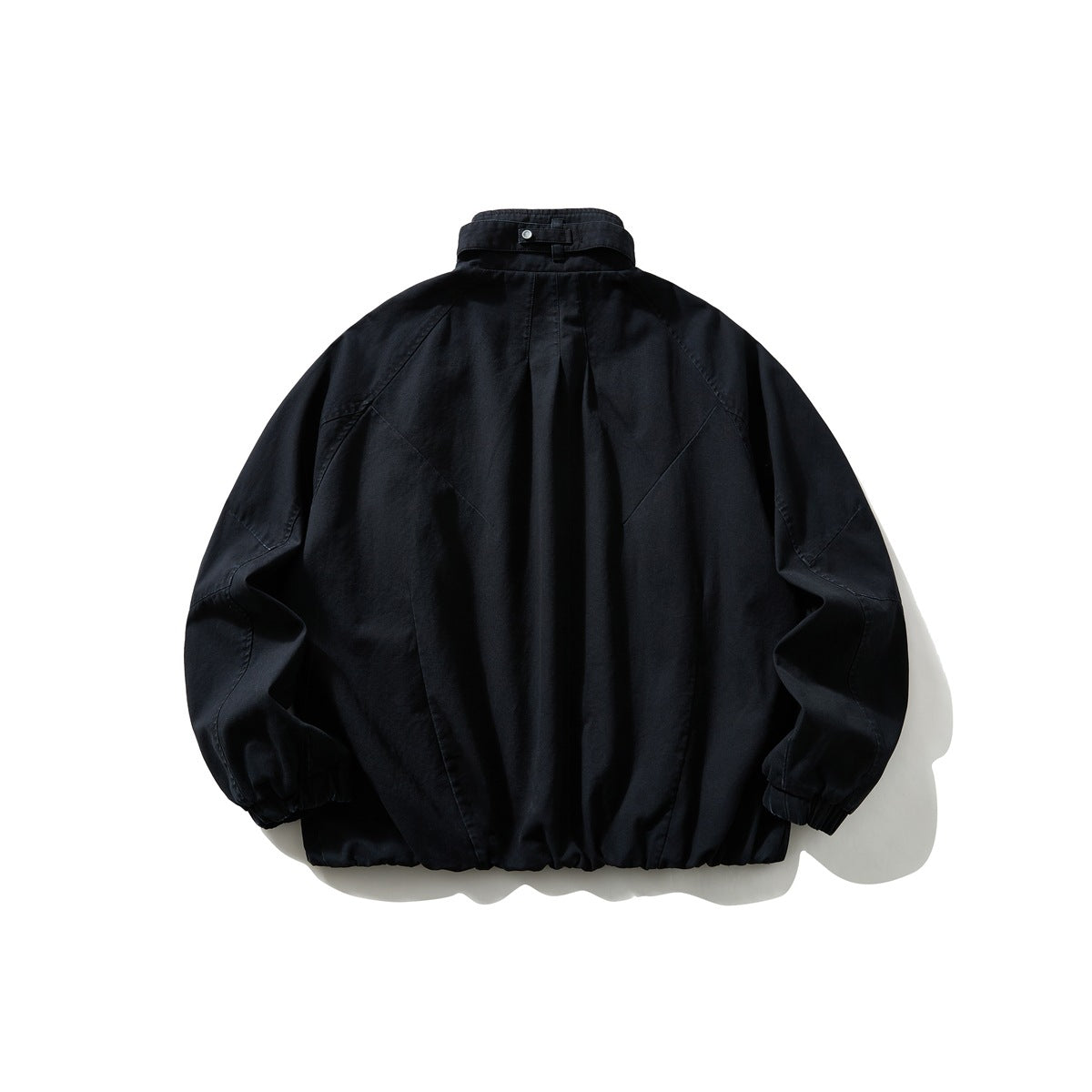Back view of navy stand-collar jacket with center pleat, raglan seams, elastic cuffs and gathered hem