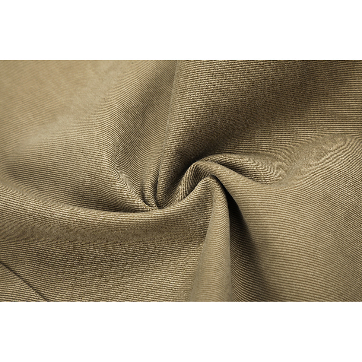 Close-up of khaki fabric gathered into folds, showing its fine diagonal weave.