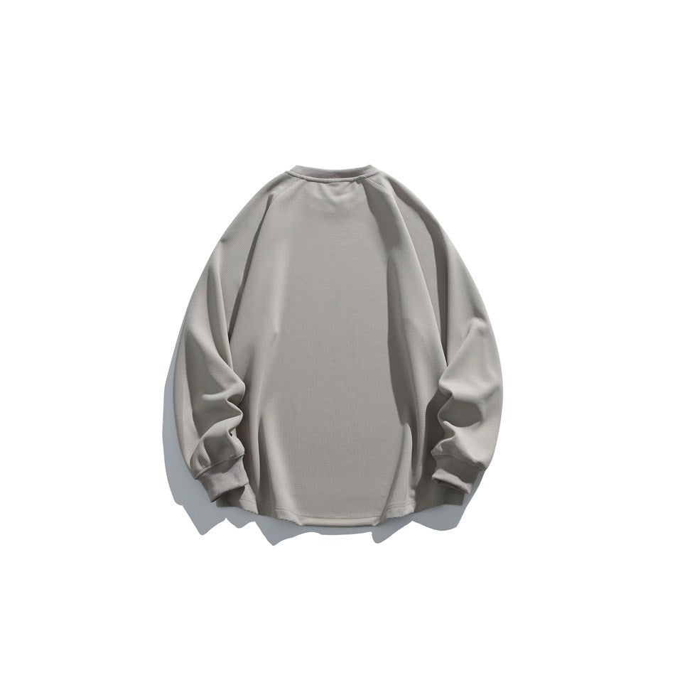 Back view of a plain light gray crewneck sweatshirt with long raglan sleeves and ribbed cuffs.