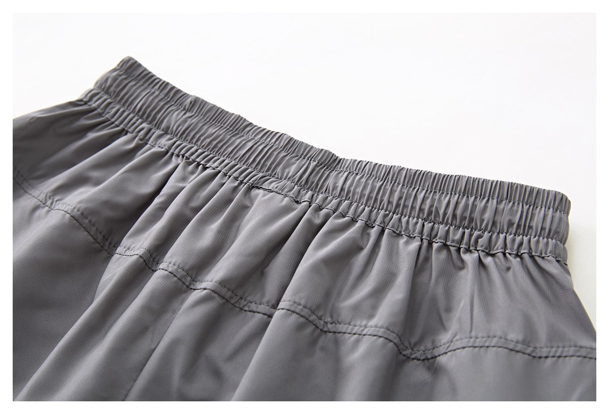 Close-up of the gray shorts' gathered waistband and stitched back yoke.
