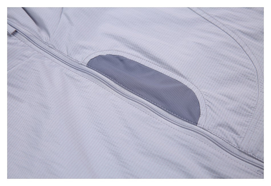 Close-up of a pale gray-lavender jacket with a diagonal zipper and a dark perforated fabric panel.