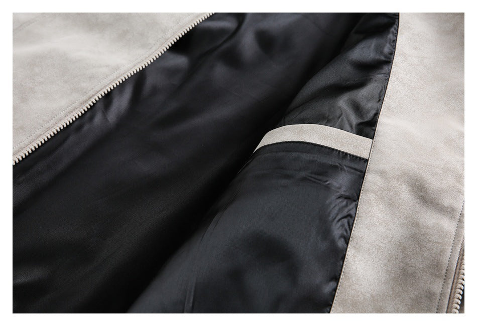 Close-up of the jacket opened to show its black lining, inner pocket, and light-colored zipper.