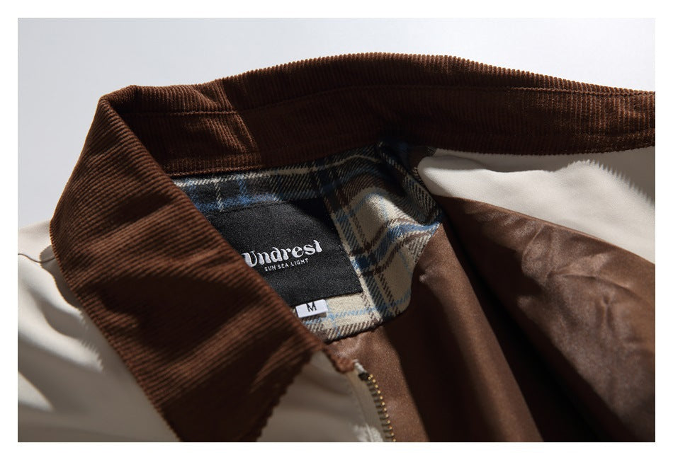 Close-up of a brown corduroy collar and plaid inner neck panel with a sewn brand and size label.