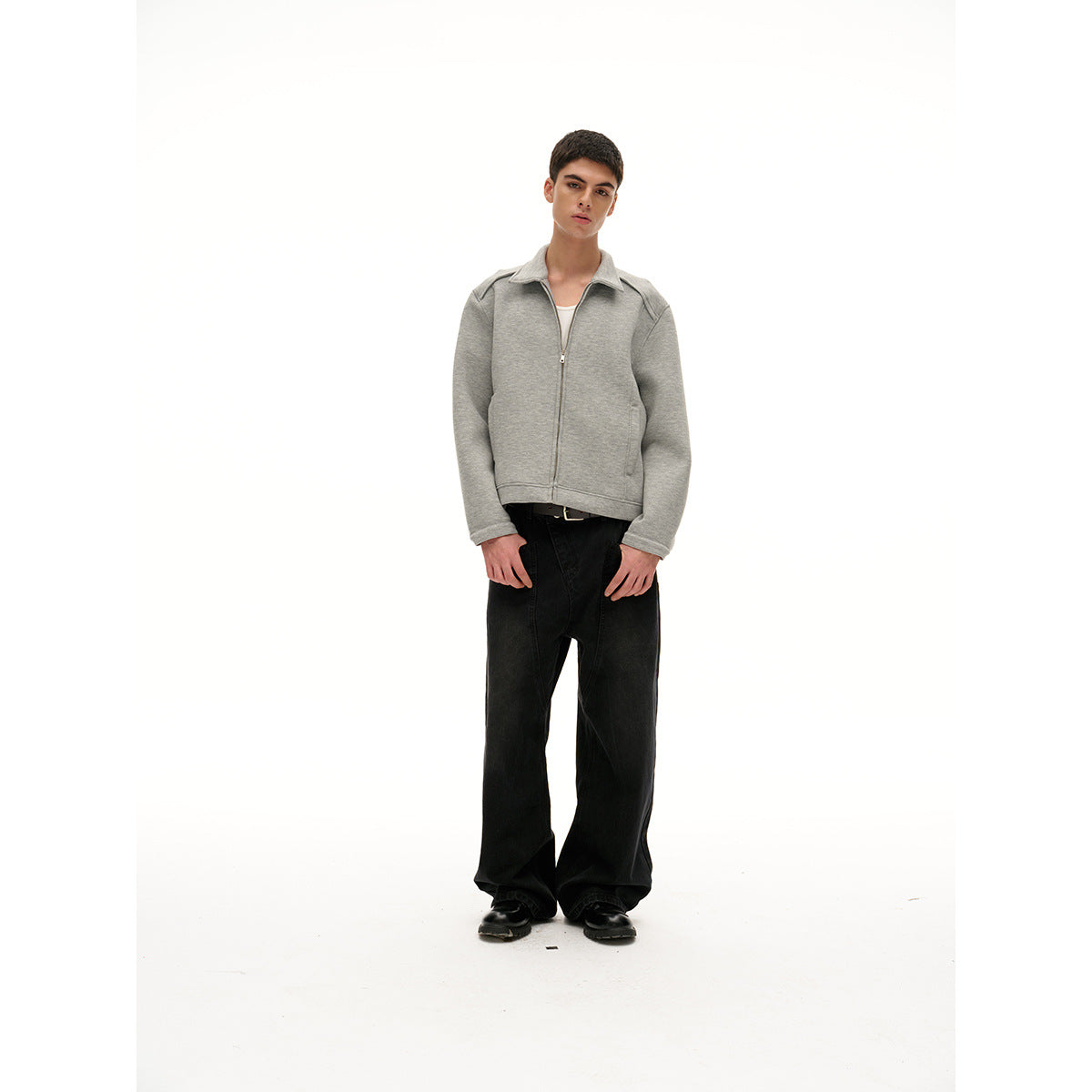 Full-length model wearing a light gray collared zip jacket and black wide-leg pants against a white background.