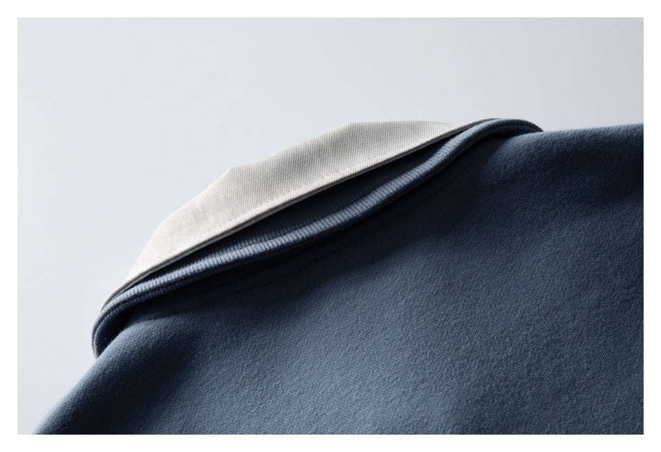 Close-up of the light-colored collar layered over the blue garment neckline.