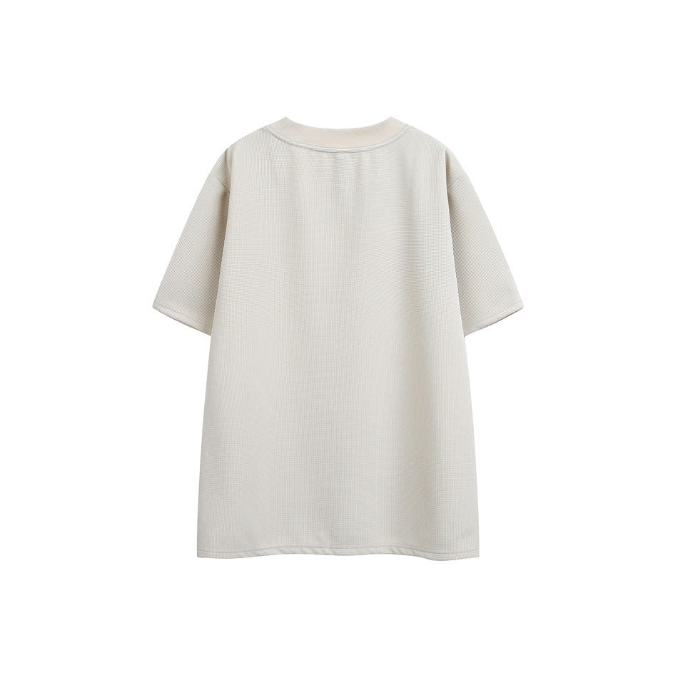 Back view of an off-white short-sleeve T-shirt with a crew neck and textured surface.