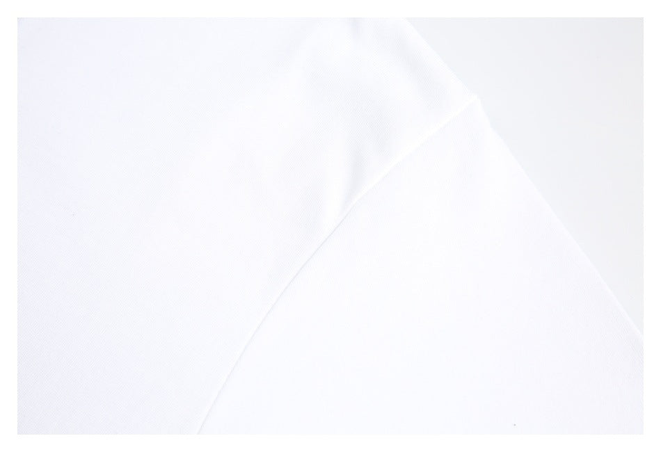 Close-up of white shirt fabric and a diagonal stitched seam.