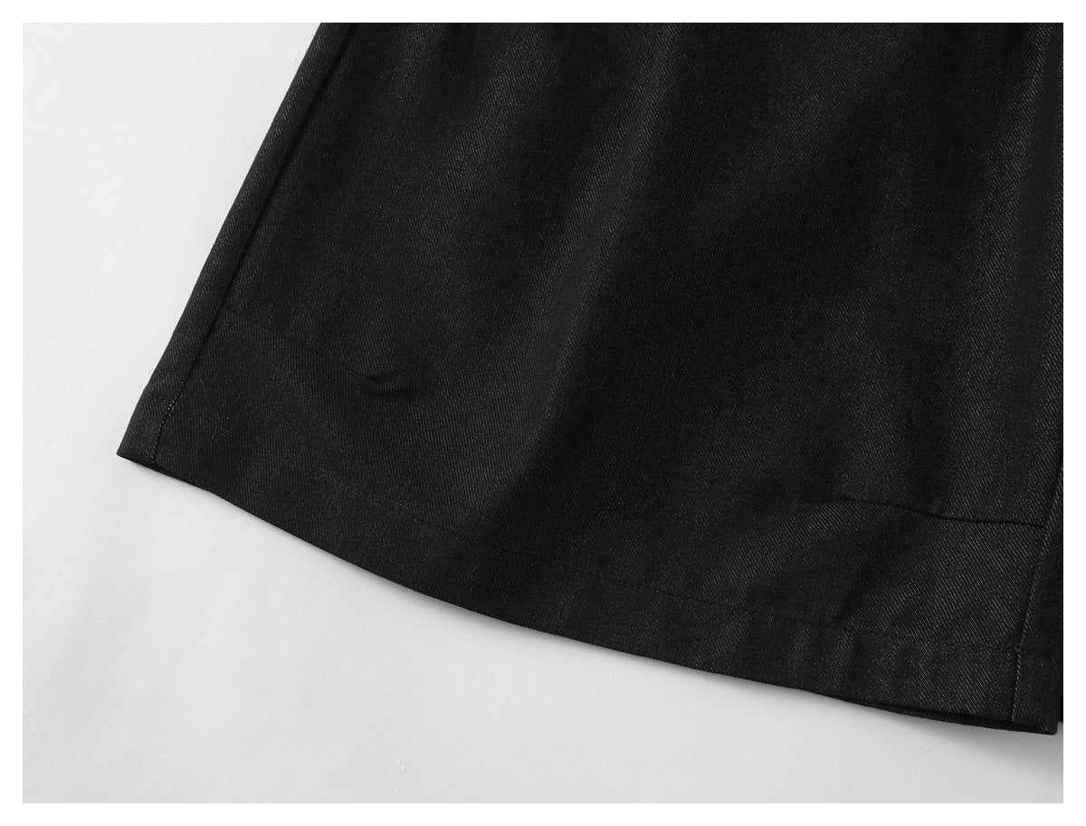 Close-up of the hem and stitching on black trousers.