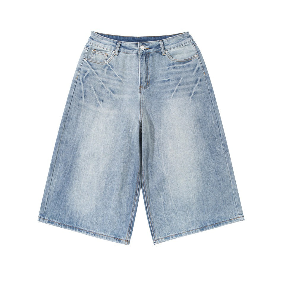 Light wash blue knee-length wide-leg denim shorts with faded whiskering, flat lay front view