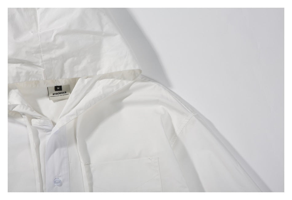Close-up of the white jacket’s hood, button placket, and chest pocket.