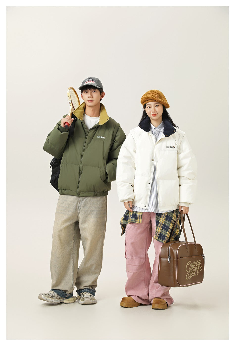 Two models wear an olive padded jacket and a white padded jacket with a navy collar in a studio.