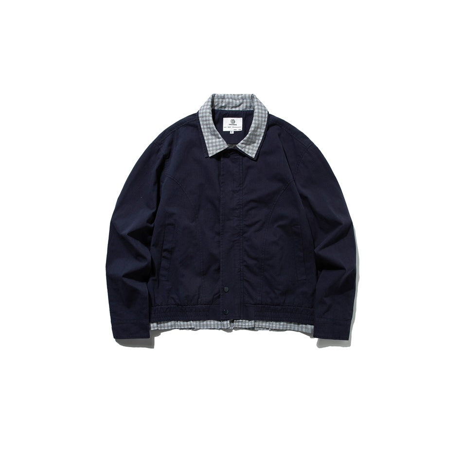 Navy jacket flat lay, front view, with check collar, snap placket, slanted pockets and check layer below the hem