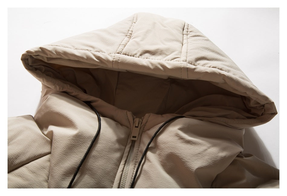 Close-up of the jacket's hood, black drawcords, and upper zipper.