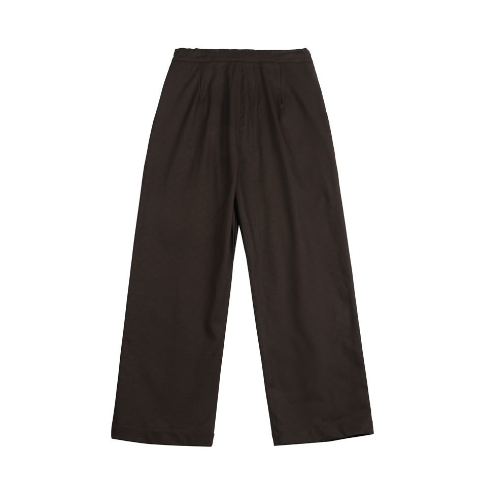 Back view of dark brown wide-leg trousers with waistband and seam details, flat lay on white